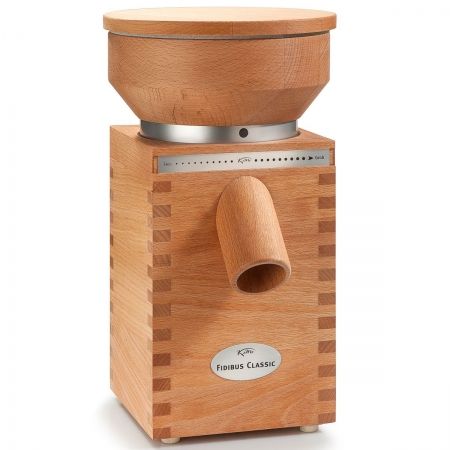 This is a picture of an electric grain mill that is wood grain. It has a top hopper compartment and a tube coming out of the front where the flour comes out milled.