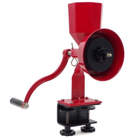 This is a picture of a red, metal, manual grain mill. It has a lever with a black platic handle. It has 2 dials that clamp the mill to the table top. The hopper on top of the mill is also red and opens to the top.