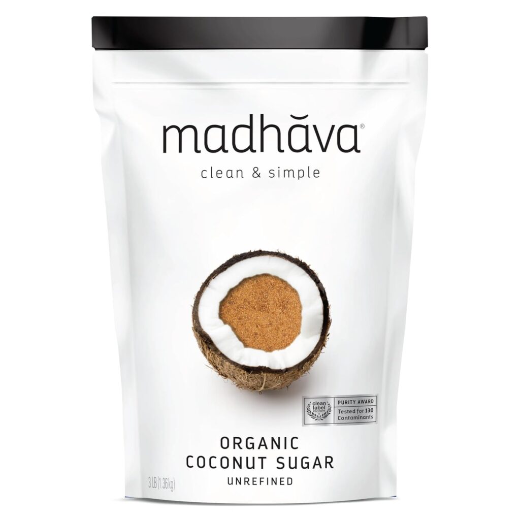 This image is of a white bag with a black seal along the top. It is Madhava, clean and simple brand. Has a coconut, split open and full of coconut sugar in the center. It says, "organic coconut sugar" along the bottom.