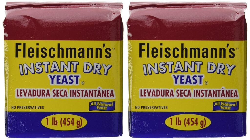 This image is of 2 bags of yeast. The brand is Fleischmann's, Instant yeast. The packaging is red on top, yellow in the center and blue on the bottom. 