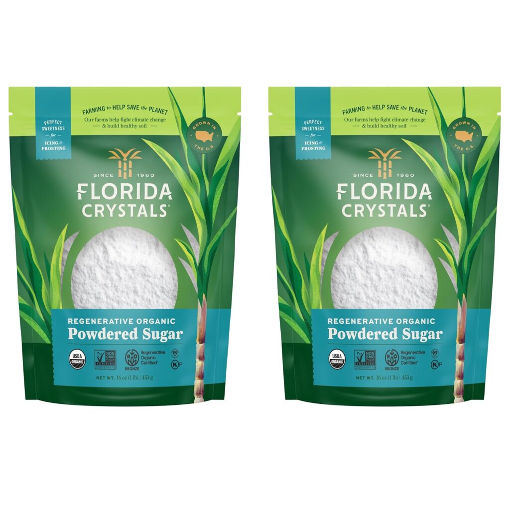 This image is of 2 bags of powdered sugar, labeled "florida crystals, regenerative, organic, powdered sugar." The bags are green with a turquoise lable along the bottom and a clear window to show the powdered sugar.