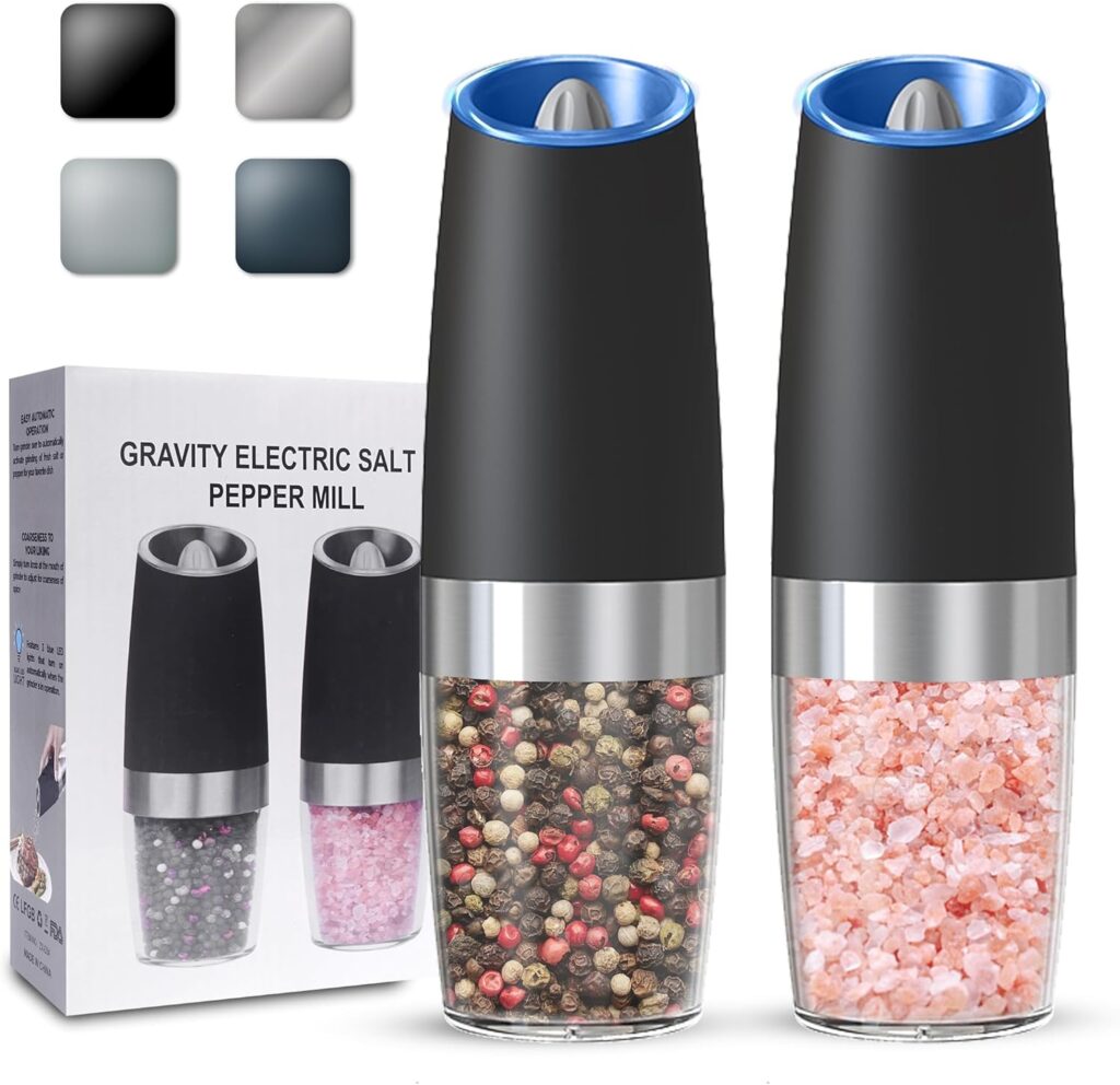 This image is of 2 salt and pepper grinders. They contain colorful peppercorns in one and pink salt crystals in the other. The box for the grinder is behind and the color options displayed in the top left. If you are shopping Bailey Basic's Kitchen, this is a must.