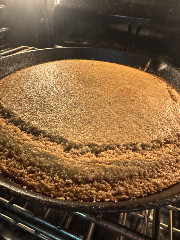 This image is of a cast iron skillet filled with cooked cornbread.