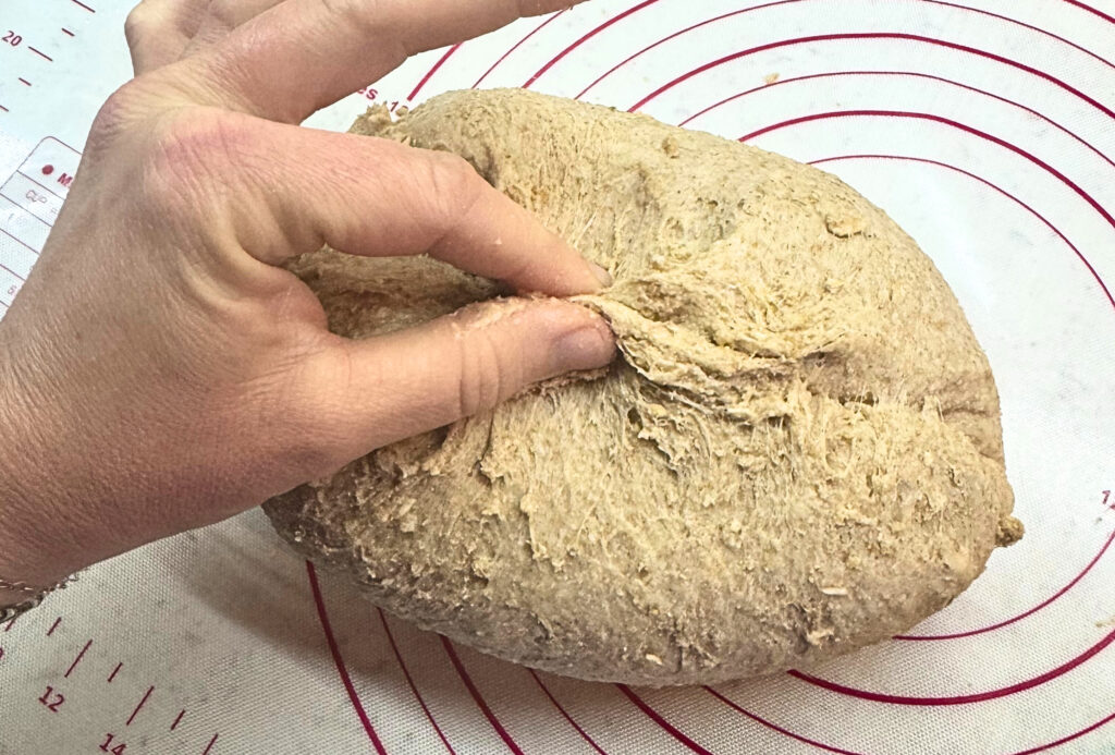 Pinching the dough for honey oat wheat bread loaf