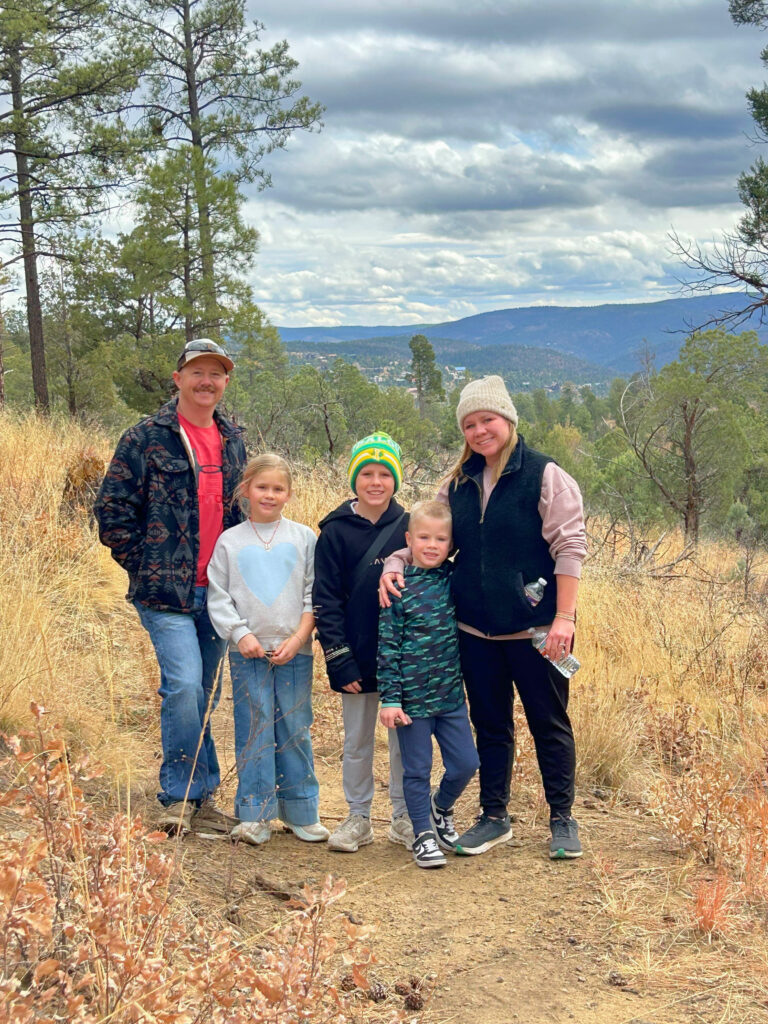Family photo after bailey basics was created. Family is in front of a mountain.