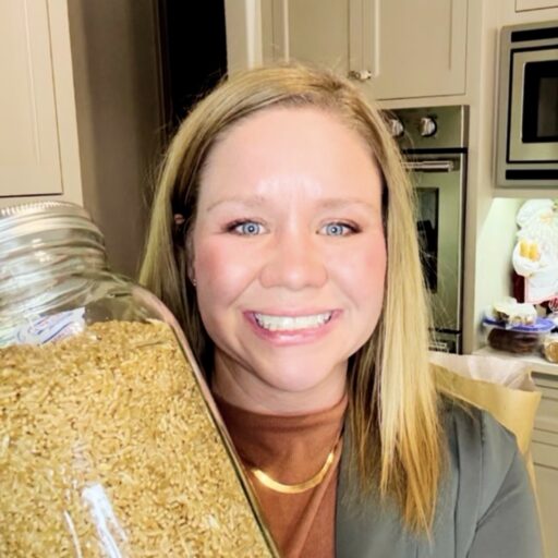 Krista Bailey from Bailey Basics. Holding a jar of wheat berries for baking fresh milled flour recipes